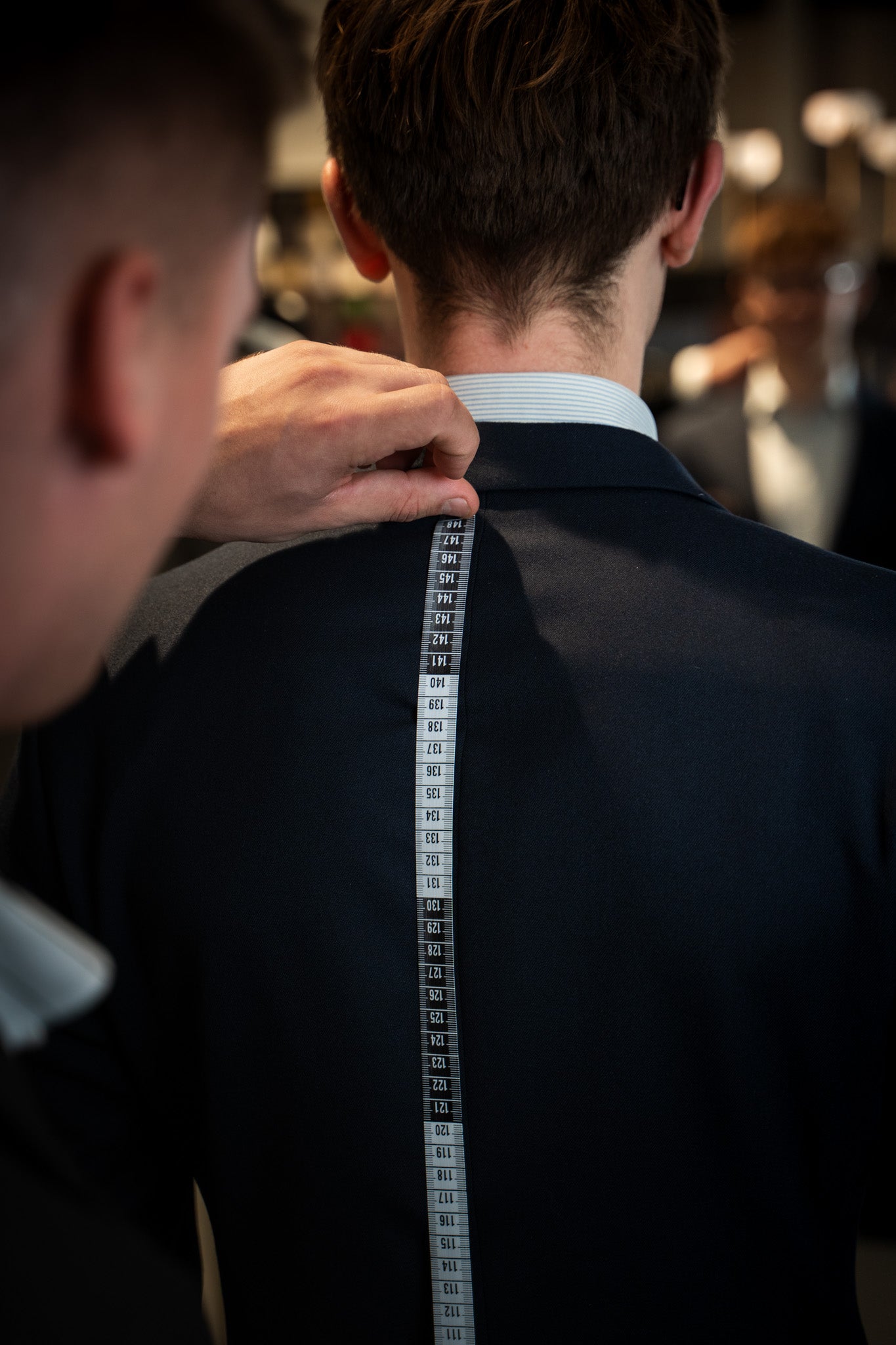 Opmåling af jakkesæt med målebånd